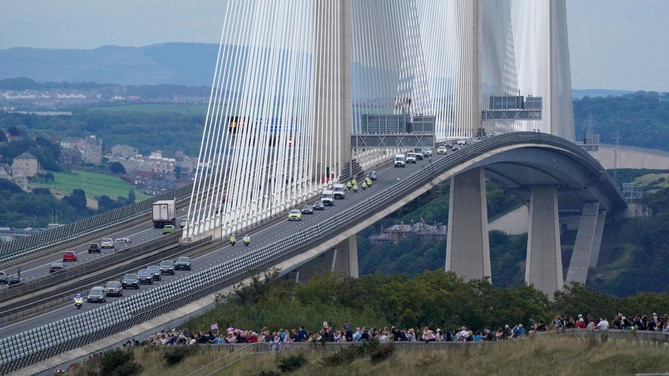 Crowds watch the funeral cortege of the Queen travel over the Queensferry bridge