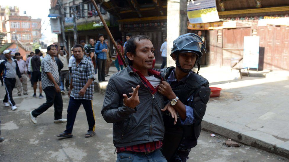 Nepalese arrest a protester in Kathmandu on 20 September 2015