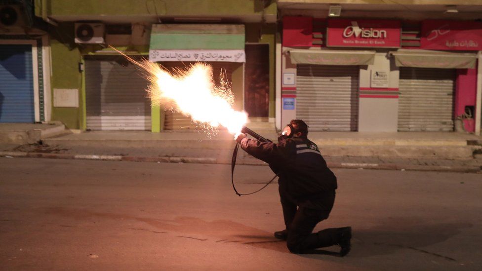 A member of Tunisia's security forces firing at protesters