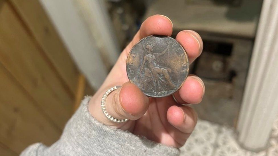 Someone holding an old coin