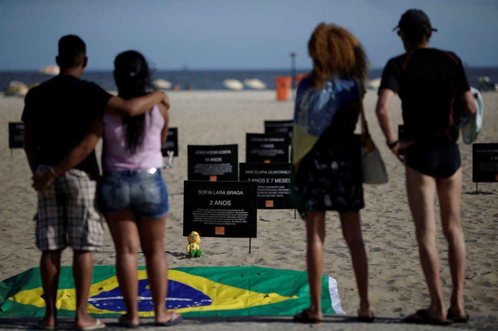 Signs that bear the names of children killed by stray bullets are seen during a protest calling for an end to the violence that erupts during police operations against suspected drug traffickers and thieves, at the Copacabana beach in Rio de Janeiro