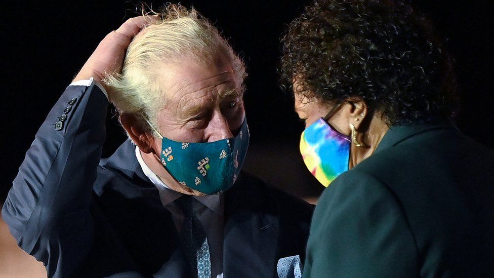 Prince Charles speaks with Barbados president-elect Sandra Mason as he arrives at Grantley Adams Airport