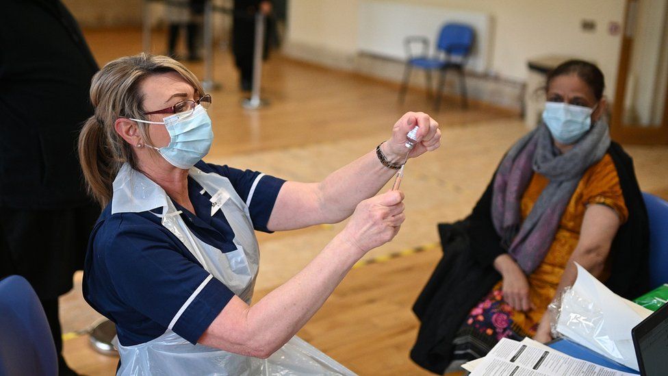 A nurse administers a dose of the AstraZeneca-Oxford Covid-19 vaccine to a patient