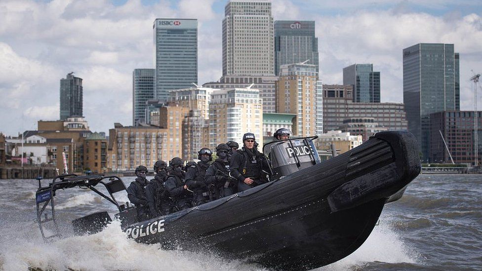 Armed Metropolitan Police counter terrorism officers take part in an exercise on the River Thames in London on August 3, 2016.