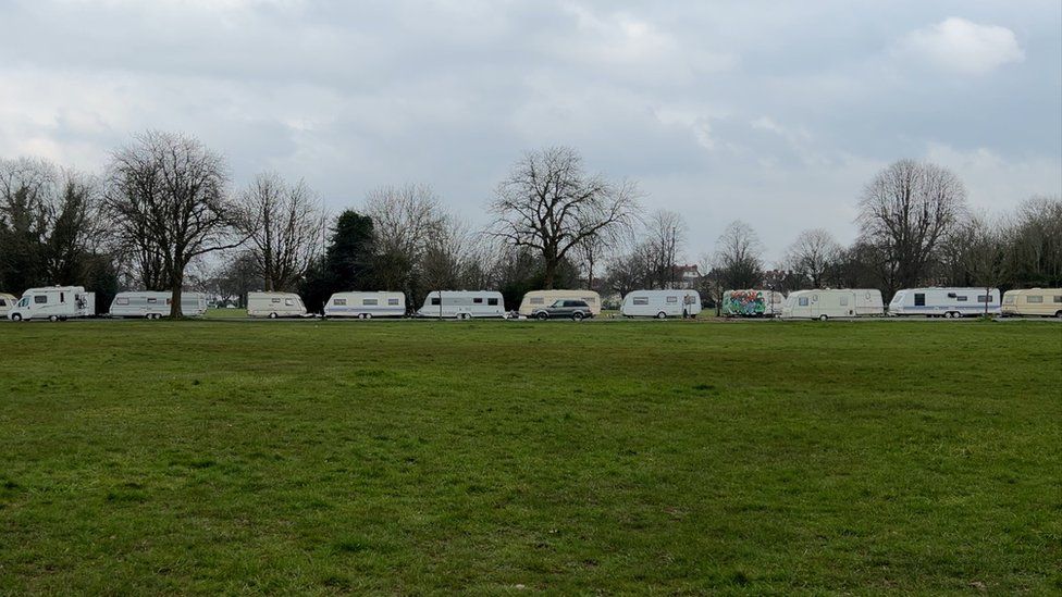 Caravans and vans lining a road on the Downs in Clifton, Bristol