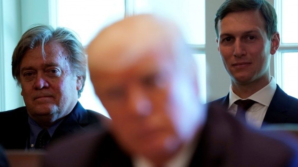 Trump advisers Steve Bannon (L) and Jared Kushner (R) listen to US President Donald Trump