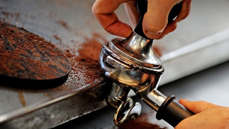 A tamper is used to prepare coffee grounds at the 'Met Cafe', a popular cafe in Sydney