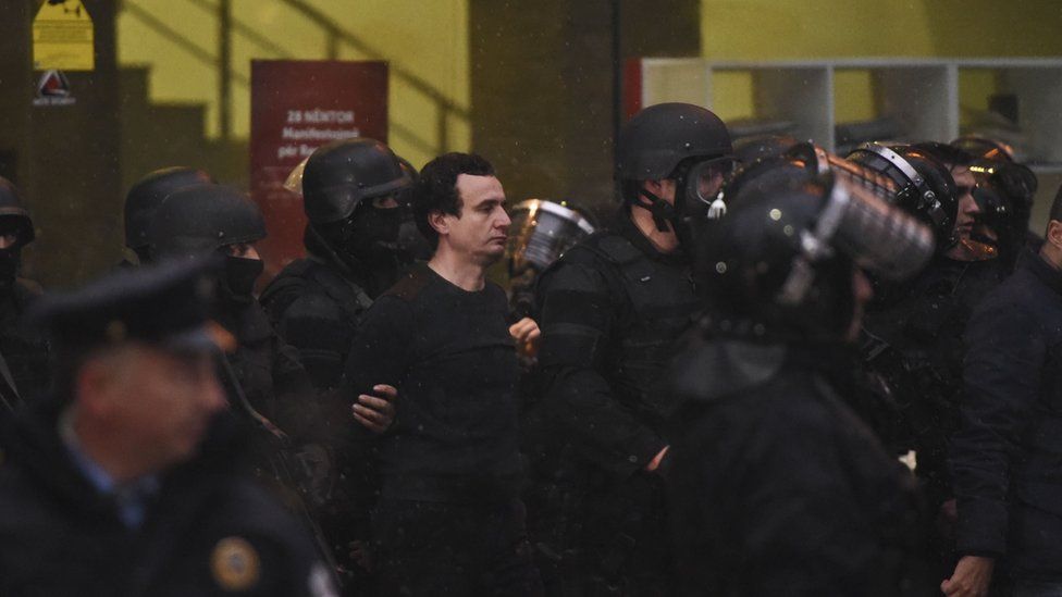 Kosovar policemen detain opposition lawmaker Albin Kurti (C) at the Vetevendosje headquarters