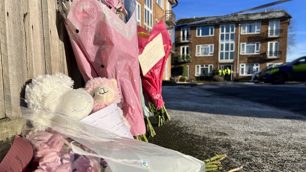 Flowers in Petherton Court in Kettering following the deaths of one woman and two children