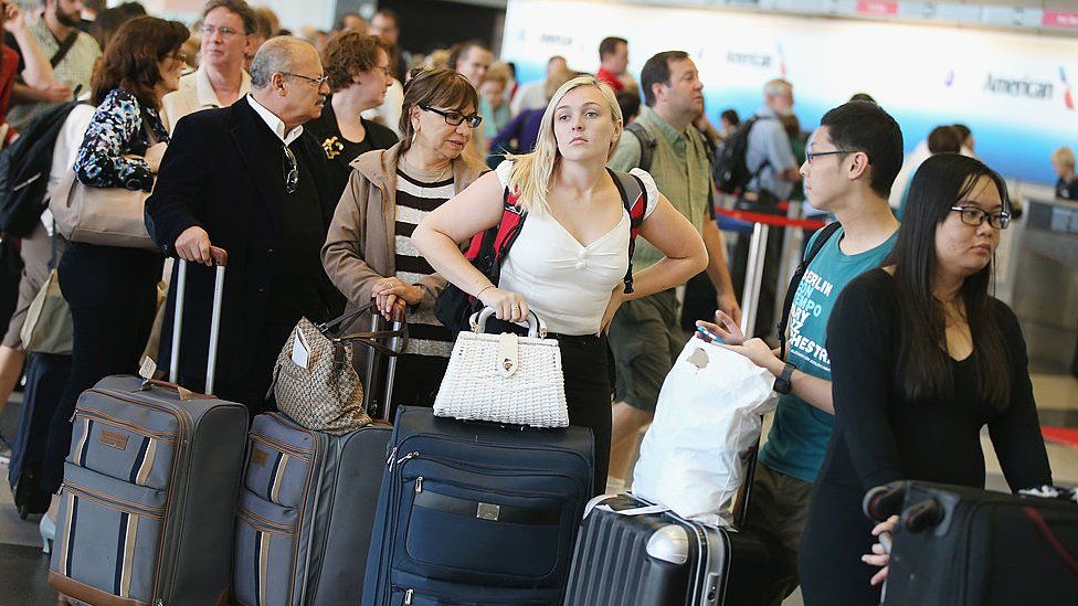 People queue at an airport