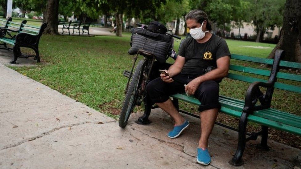 A man connects to the internet at a hotspot in a public park in Havana, Cuba, July 14, 2021.