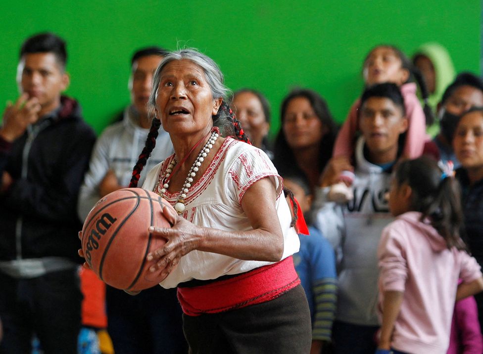 Andrea Garcia Lopez, 71, plays basketball during an exhibition game in San Esteban Atatlahuca, Oaxaca, Mexico August 3, 2022.