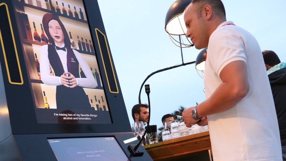 A man using a Cecilia robot bartender