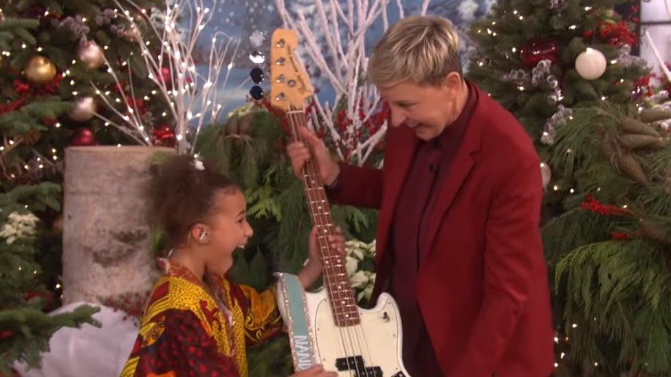 Nandi Bushell looking happy when she receives the guitar from Elle DeGeneres