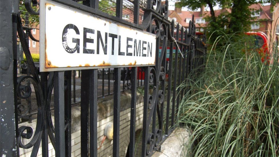 Gentlemen sign outside a public convenience at South End Green near Hampstead Heath, north London