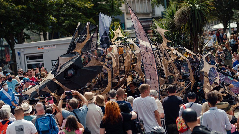 Giant dragon puppet show draws crowds to Plymouth BBC News