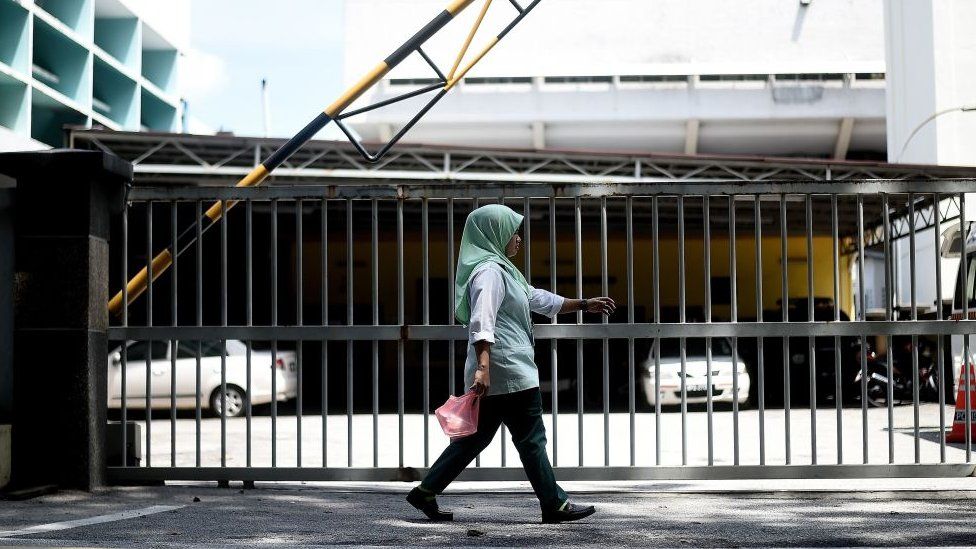 A woman walks past the forensics wing of the Hospital Kuala Lumpur in the Malaysian capital