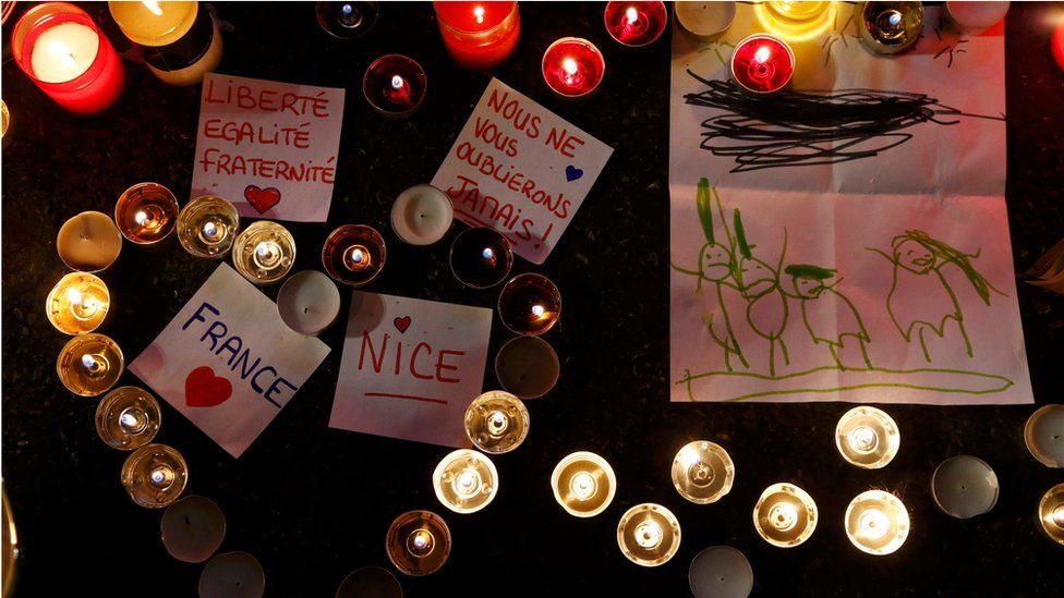 Burning candles, messages and a drawing pay tribute to victims of the truck attack along the Promenade des Anglais on Bastille Day that killed scores and injured as many in Nice, France, 17 July 2016.
