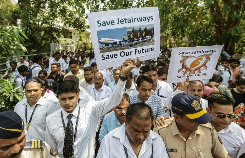 Indian Jet Airways employees hold placards and shout slogans against their company"s management as they march towards the Jet Airways head office from the Chhatrapati Shivaji Maharaj International Airport