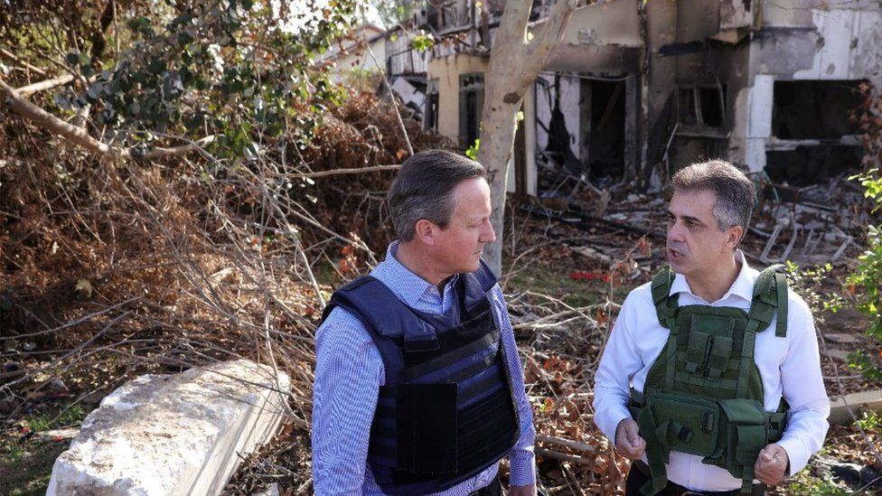 Foreign Secretary Lord Cameron is shown some of the damage caused by the Hamas attack on a kibbutz