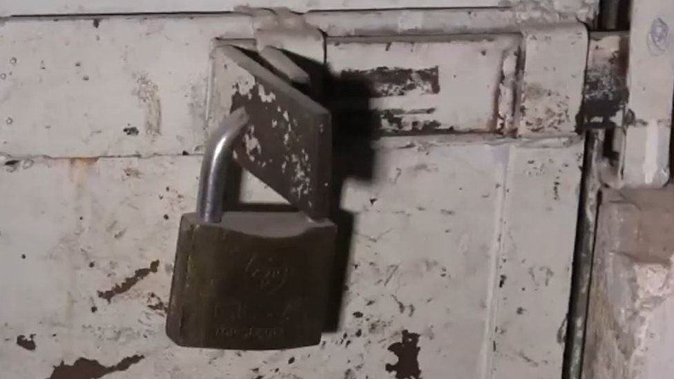 A photograph of a padlocked door in an Islamic State prison in Raqqa
