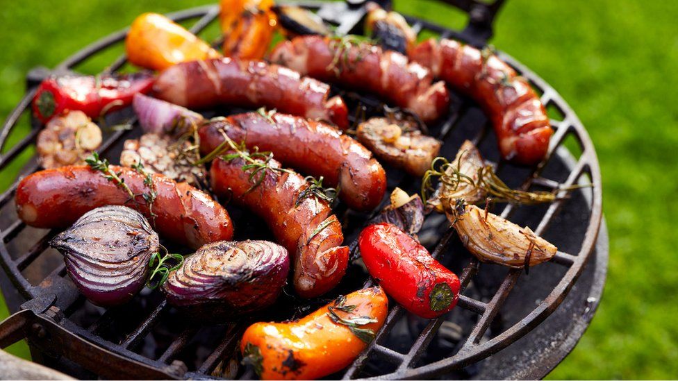 Grilled sausages and vegetables on a grilled plate
