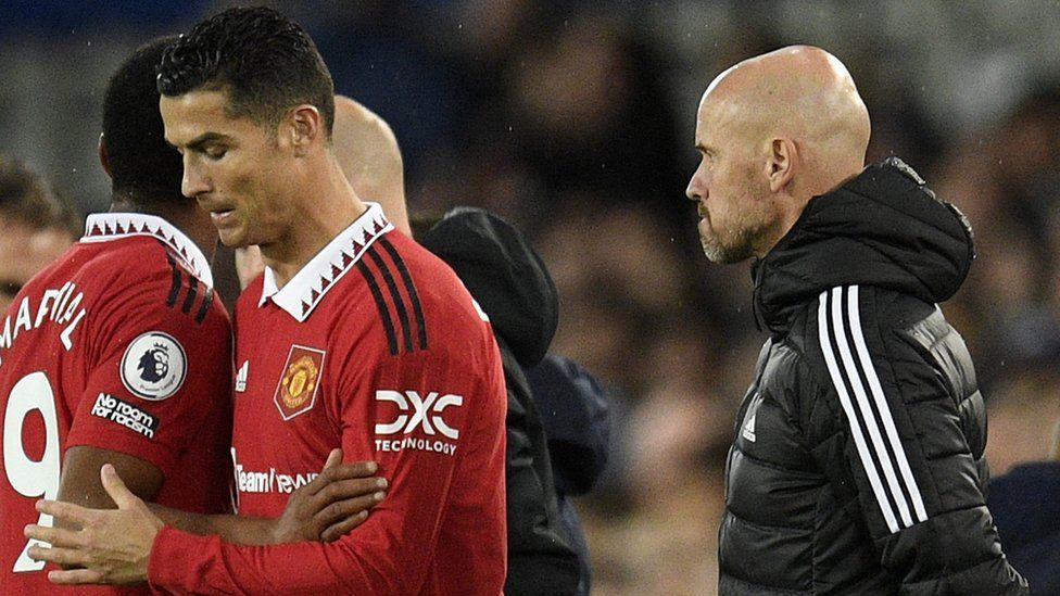 Manchester United's Dutch manager Erik ten Hag (R) watches as Manchester United's Portuguese striker Cristiano Ronaldo (C) is subbed on for Manchester United's French striker Anthony Martial (L) during the English Premier League football match between Everton and Manchester United