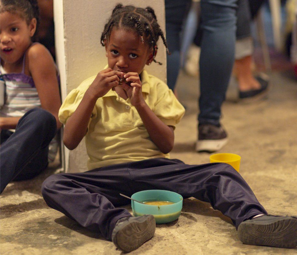 Child eating at social programme in Caracas