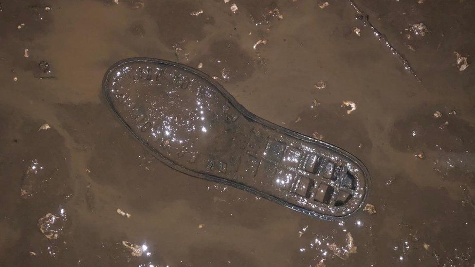 A shoe stuck in mud