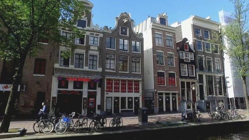 Amsterdam houses with bikes in front of them