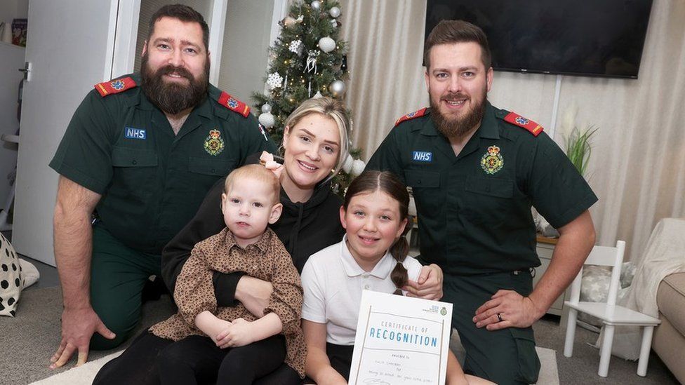 North East Ambulance Service team with 10-year-old Lucia Charlton, two-year-old sister Blake and mum Stephanie Wilde