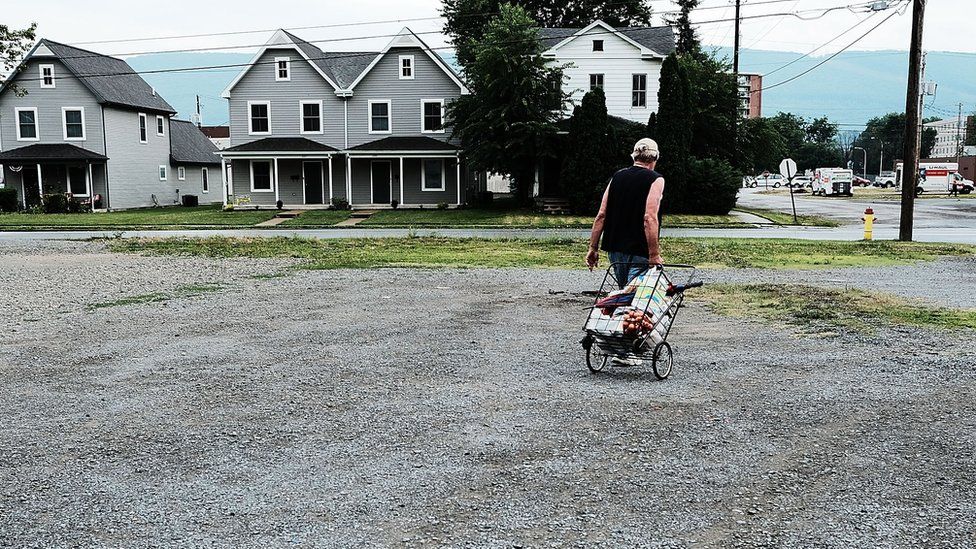 A man pulls a shopping trolley