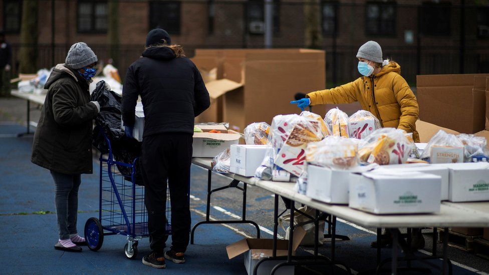 A woman organizes food donated by City Harvest Mobile Market Food Distribution Center, during the outbreak of the coronavirus disease (COVID-19) in the Brooklyn borough of New York, U.S., April 15, 2020.