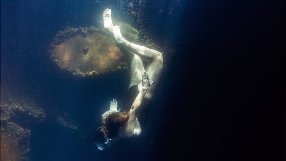 A snorkler dives to identify species growing on the hull of a ship during a marine biology survey in the Indian Ocean in False Bay, Cape Town, South Africa, 22 December 2018