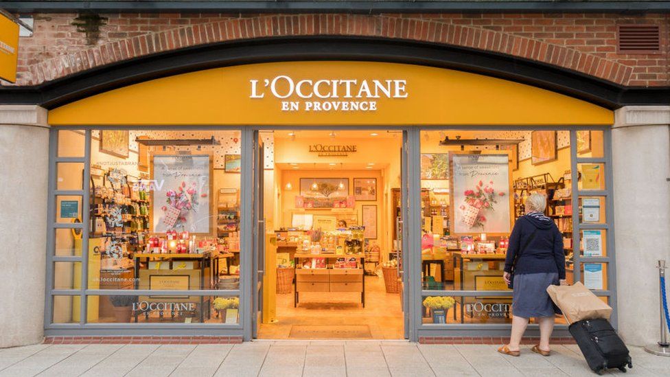 A woman stands outside a L'Occitane en Provence at the Gunwharf Quays Shopping Centre in Portsmouth.