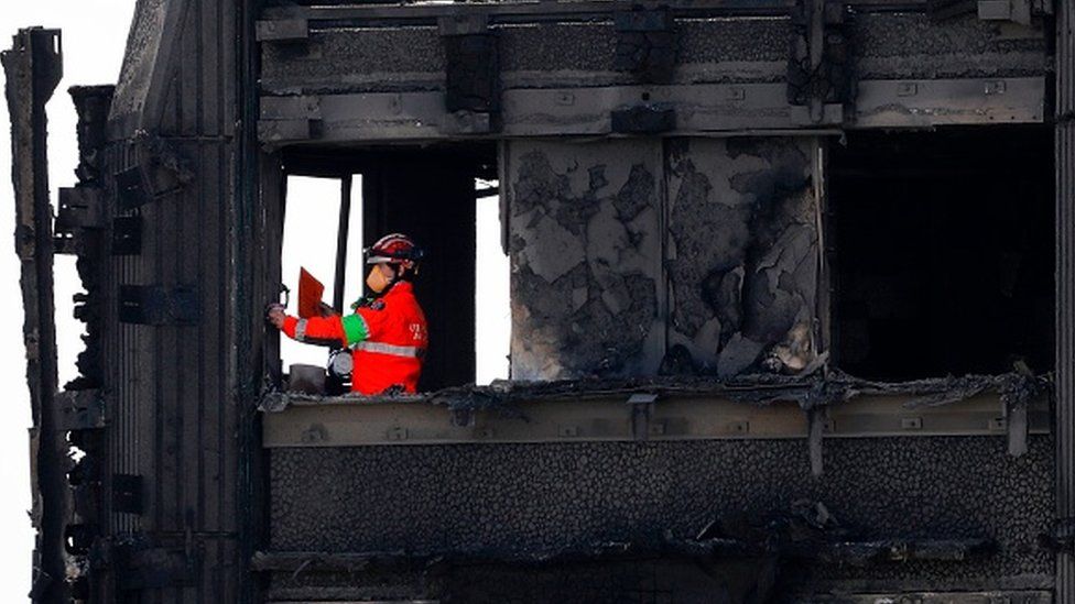 The emergency services work on the charred remains of Grenfell Tower