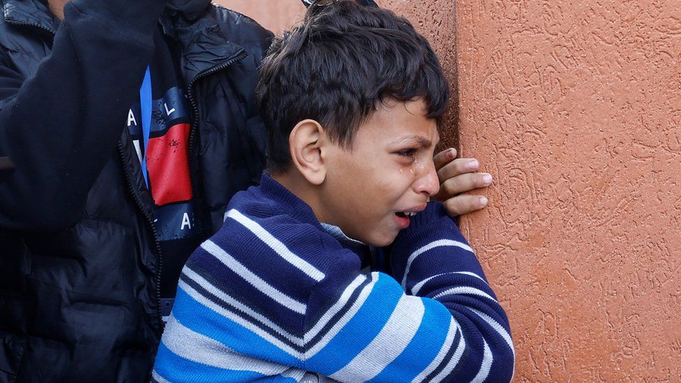A Palestinian boy reacts, as he attends the funeral of Palestinians killed in an Israeli raid, amid the ongoing conflict between Israel and the Palestinian Islamist group Hamas at Nasser hospital in Khan Younis, in the southern Gaza Strip,