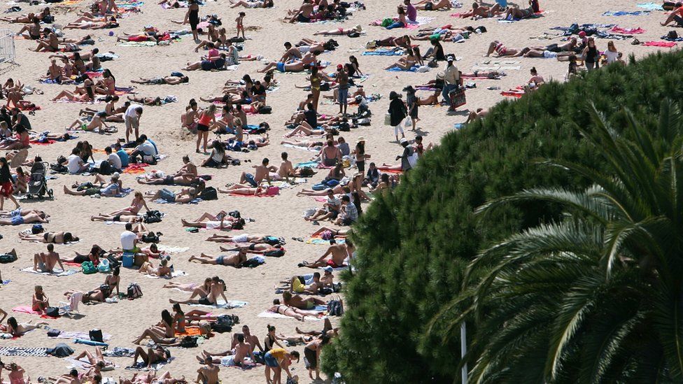 People sunbathing on the beach in Cannes