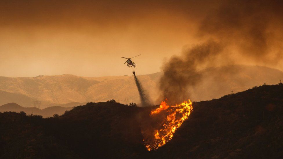 A firefighting helicopter drops water at the Sand Fire on July 23 2016 near Santa Clarita, California