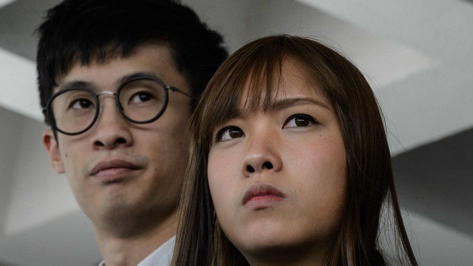 In his file photo taken on 30 November 2016 shows pro-independence lawmakers Baggio Leung (L) and Yau Wai-ching speaking to the press outside the High Court in Hong Kong.