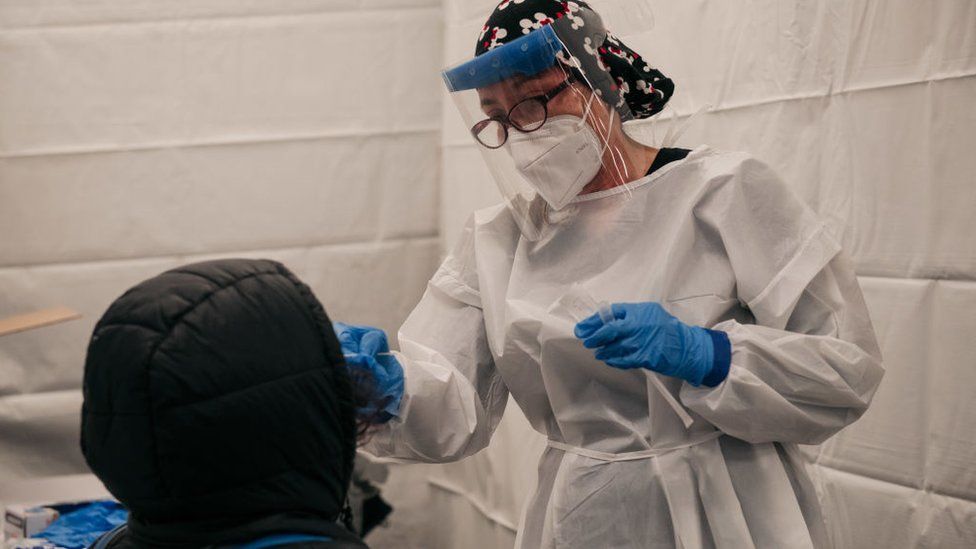 A medical worker administers a Covid-19 test at a new testing site inside the Times Square subway station on 27 December