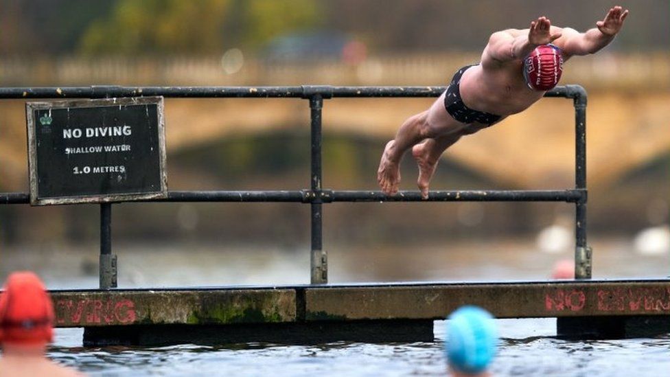 A swimmer takes to the water at Serpentine Swimming Club
