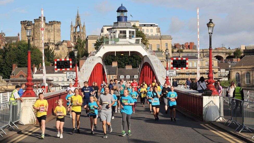 Young runners cross the Swing Bridge as part of the Mini and Junior Great North Runs