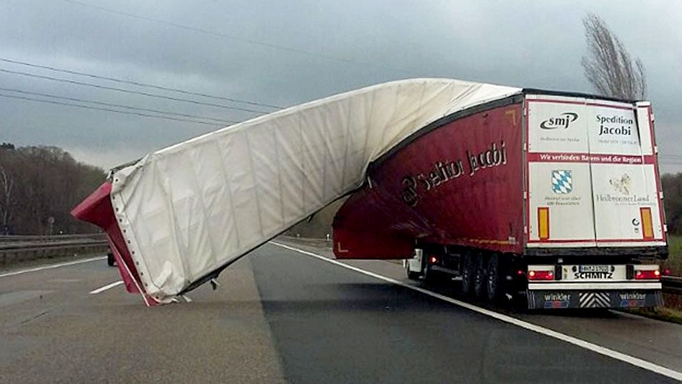 A truck's tarpaulin is blown off on to the motorway due to strong winds near Wuppertal, Germany