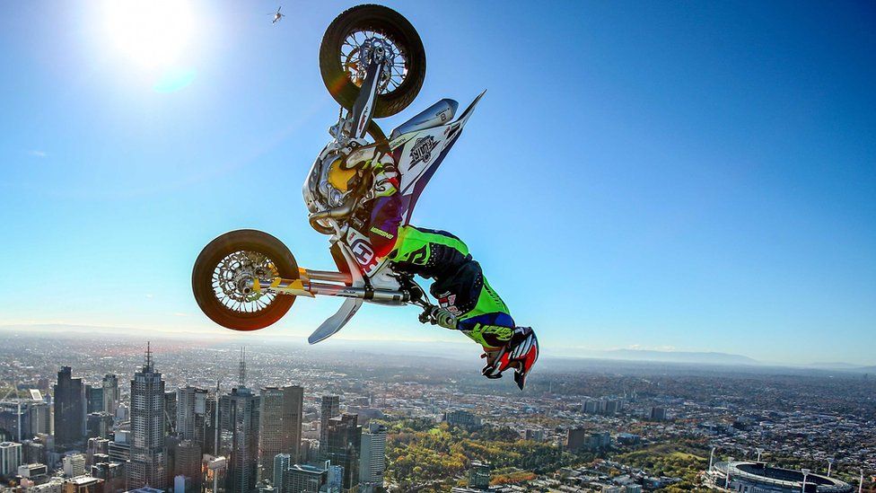 World Champion Trials bike rider Jack Field of Australia performs a back flip on a motorcycle