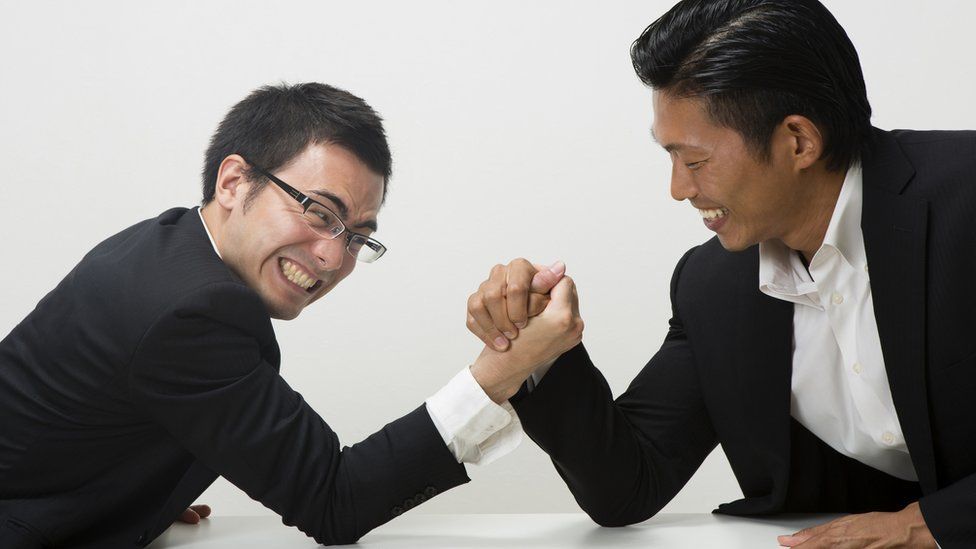 Two businessmen armwrestling