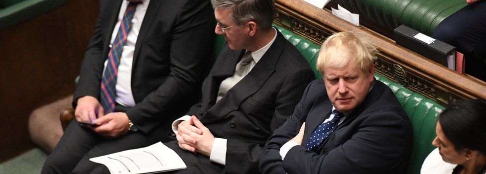 Boris Johnson sitting in the House of Commons