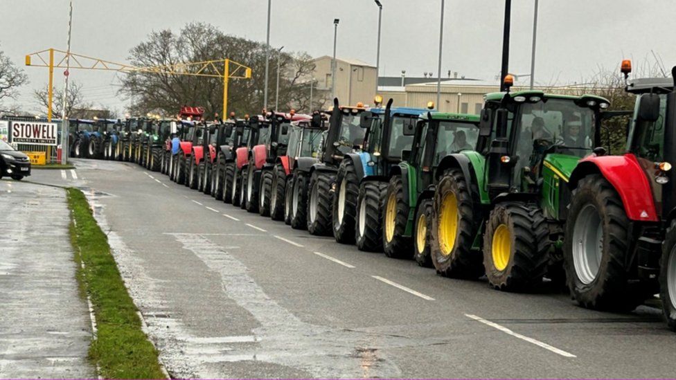 A line of tractors ready to start the procession