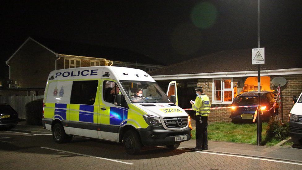 Police outside the damaged house