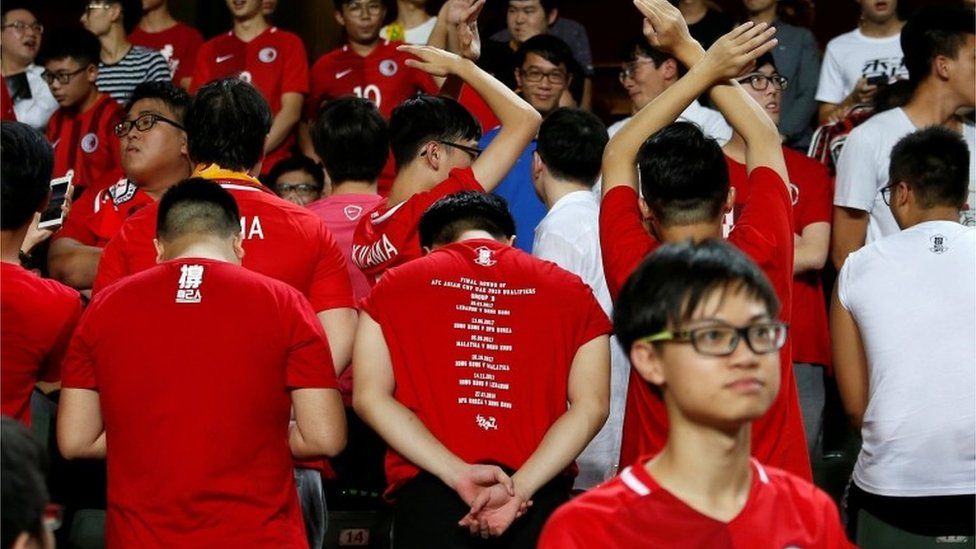 Hong Kong fans turn their backs as the Chinese national anthem is played at a match against Malaysia, 1 November 2017